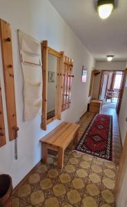 a room with a wooden bench and a table at ciao-aschau FeWo Beckmann in Aschau