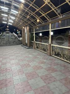 a large room with a stone floor and a ceiling at Tet-A-Tet in Qarasū