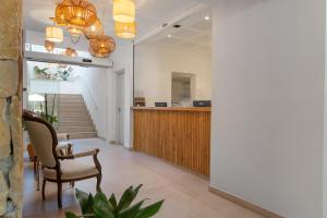 an office lobby with a desk and chairs and stairs at Villa Real Club Apartments in Camp de Mar