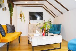 a living room with two chairs and a coffee table at Manoir Drissia - Tours Centre, France in Saint-Avertin +31 photos