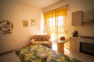 a kitchen with a table and a chair in a room at Casa vacanza Sa Ferula in Flumini di Quartu +25 photos