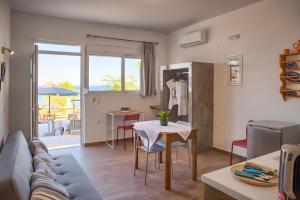 a living room with a couch and a table at La mer stegna in Archangelos +9 photos