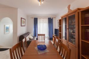 a dining room with a wooden table and chairs at FLH Large Ericeira House with Terrace in Ericeira
