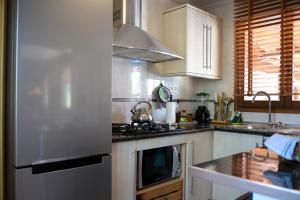 a kitchen with a stainless steel refrigerator and a stove at PALMITO in Villena