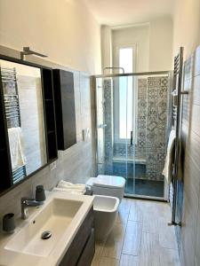 a bathroom with a sink and a toilet and a shower at Milano Flat - Primaticcio in Milan