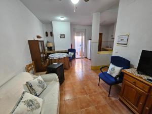 a living room with a couch and a table and a kitchen at Corralazo B in Calasparra