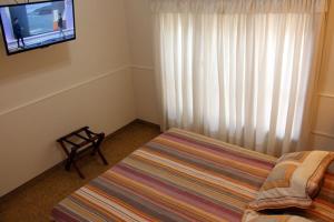 En eller flere senge i et værelse på Departamentos Cervantes UNO