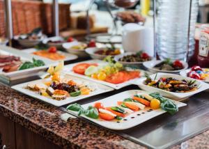 a buffet with several plates of food on a counter at Arcade Hotel in Wuppertal