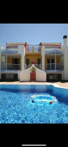 a large swimming pool in front of a building at Niriides in Kyparissia