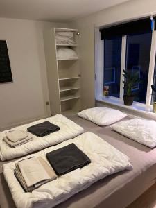 two beds with towels on them in a room at Casa House of Bricks 2 - LEGOLAND 650m in Billund
