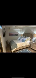 a bedroom with a large bed and a night stand at 2 bedroom Apt in long branch in Long Branch