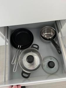 a stove with three pans and utensils in a drawer at Casa House of Bricks 2 - LEGOLAND 650m in Billund