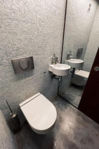 a bathroom with a toilet and two sinks at Cabanon Le Perchoir des Goudes in Marseille