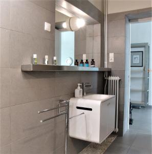 a bathroom with a white sink and a mirror at SQUARE 45 in Chania Town