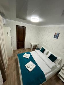 a bedroom with a large bed with a blue blanket at garden and panorama in Mtskheta