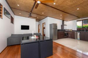 an open kitchen and living room with a couch at Atupa Suites in Avatiu
