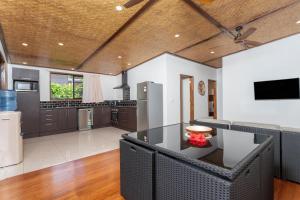 a large kitchen with a dining table in a room at Atupa Suites in Avatiu