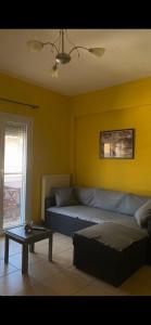 a living room with a couch and a table at Vicky's house in Olympiada