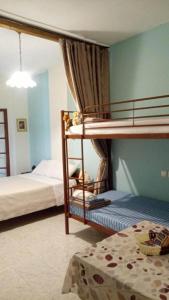 a bedroom with two bunk beds in a room at Irida Maria in Agios Ioannis Pelio