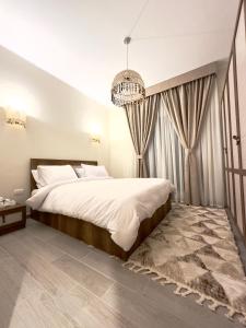 a bedroom with a large bed and a chandelier at Luxury Villa Bali Al Gouna Hurgh in Hurghada