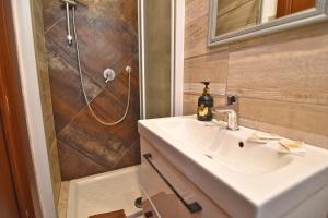 a bathroom with a sink and a shower at stanza romantica in Brandizzo +6 photos