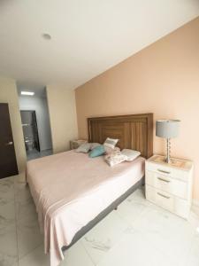 a bedroom with a large bed with a lamp on it at Casa Carola in San Rafael