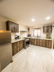 a large kitchen with wooden cabinets and appliances at Casa Carola in San Rafael