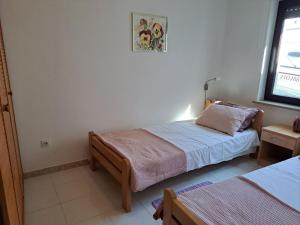 a bedroom with two beds and a window at Apartments Finera in Pomer