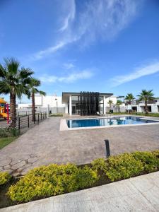 a house with a swimming pool in front of a building at Casa Carola in San Rafael