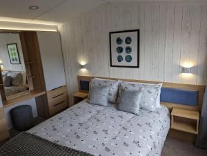 a bedroom with a large bed with pillows at Sarn Y Glyn in Mid Wales Cambrian Mountains near Llanidloes Powys in Caersws