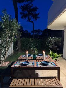 una mesa de madera con dos velas encima en Villa Usignolo, en Lignano Sabbiadoro
