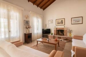 a living room with a couch and a fireplace at Villa Diana in Acharavi