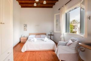 a white bedroom with a bed and a window at Villa Diana in Acharavi