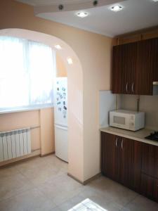 a kitchen with a white refrigerator and a microwave at Квартира на Оболоні in Kyiv