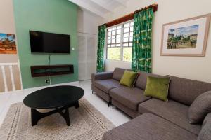 a living room with a couch and a table at 2 Bedroom Apartment at Maynards in Saint Peter