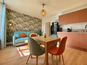 a living room with a blue couch and a table at Le TerraVerde - SOnights in Château-du-Loir