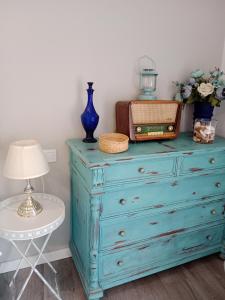 a blue dresser with a lamp on top of it at El Balcón de La Juderia in Córdoba