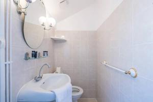 a bathroom with a sink and a toilet with a mirror at Amazing location only 3 minutes from Luxembourg Gargens in Paris