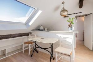 kuchnia ze stołem i krzesłami oraz oknem w obiekcie Amazing location only 3 minutes from Luxembourg Gargens w Paryżu