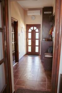 a hallway with a door and a tile floor at Dobay Apartman Gyula in Gyula