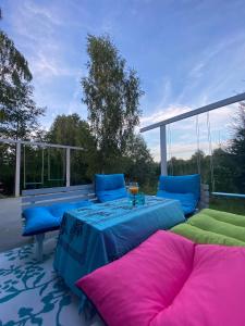 a patio with two beds and a table on a patio at Lazurowy Brzeg in Przejma Wielka
