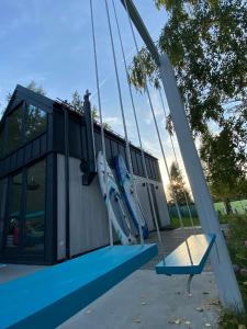 an empty playground with a slide in front of a building at Lazurowy Brzeg in Przejma Wielka