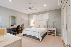 a bedroom with a bed and a desk and a desk at The Coral Door Beach House - 4315 Fourth Street in Saint Simons Island