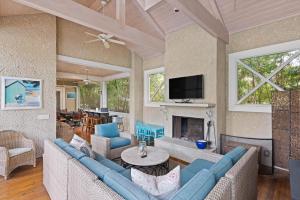 a living room with blue couches and a fireplace at The Coral Door Beach House - 4315 Fourth Street in Saint Simons Island