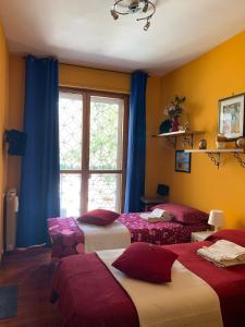 a bedroom with three beds and a window at LunaBed Roma - Affitti brevi in Rome