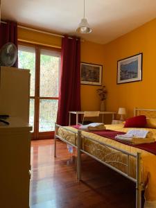 a bedroom with two beds and a large window at LunaBed Roma - Affitti brevi in Rome