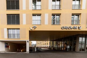 a large yellow building with a sign on it at NEW OPENING 2022 - Los Lorentes Hotel Bern City in Bern