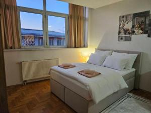 a bedroom with a large bed with two towels on it at Mrakovica 1 in Prijedor