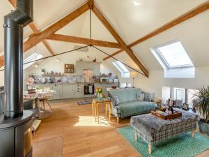 a living room with skylights and a kitchen at The Granary - Uk43356 in Branxton