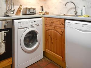 a kitchen with a washing machine and a sink at Uk46715 - The Coach House in Plumstead